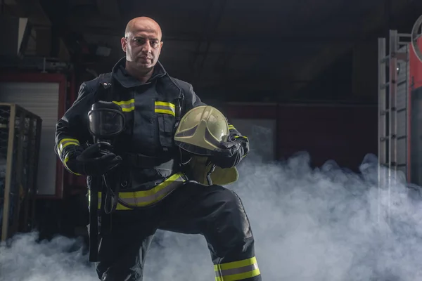 Strażak Trzymający Kask Noszący Frekwencję Strażacką Portret Strażaka Ciemnym Tłem — Zdjęcie stockowe