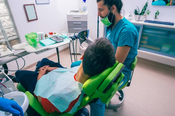 Adolescente Sentado Como Paciente Uma Cadeira Dentista Dentista Masculino Preparando — Fotografia de Stock