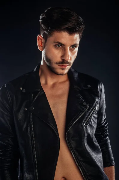 Body shot of an attractive male model posing in modern style clothing