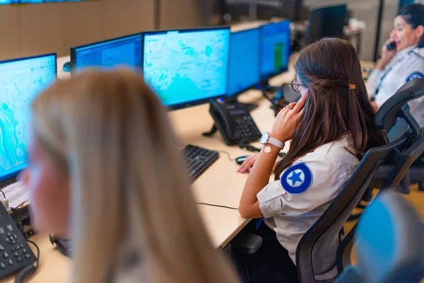 Female security guard operator talking on the phone