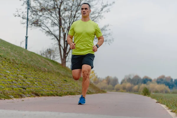 Well built middle aged athlete during a running exercise