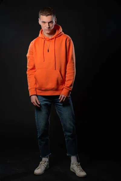 Young Handsome Man Jeans Orange Hoodie Posing While Standing Black — Stock Photo, Image