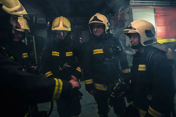 Team Firefighters Standing Indoors Buliding Next Fire Engine — Stock Photo, Image