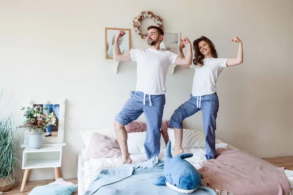 Young Couple Checks Inflated Biceps While Standing Bed Pajamas — Stock Photo, Image