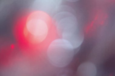 Soyut kırmızı-gri bokeh, parlak arkaplan, bulanık. Parlak ışık noktaları.