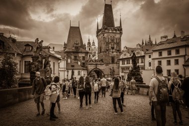 PRAGUE, CZECH REPUBLIC - AUGUST 16, 2017: Dark view of Charles Bridge (Karluv Most) and Old Town with many tourist clipart