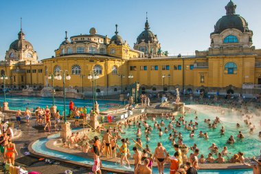 BUDAPEST, HUNGARY - JANUARY 1, 2020: Szechenyi outdoor thermal baths during the morning light with people in Budapest, Hungary