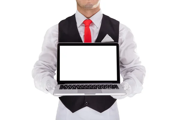 Handsome young waiter in gloves and red cravat holding laptop — Stock Photo, Image