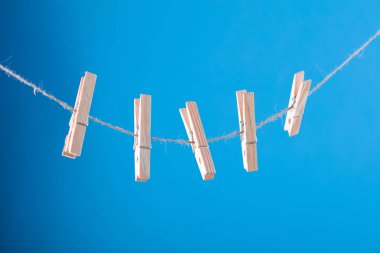 Boş kartı clothesline üzerinde sabitlenmiş. İfadelere için coppy alanı. Çiçek pimleri ile tutturulmuş. Mavi, turuncu arka plan. Yüksek çözünürlüklü fotoğraf.