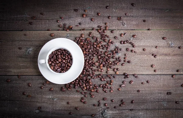 Black roasted coffee beans and grind with spices cinnamon, anise, cardamom, clove and brown sugar. With black vintage coffee grinder, scoops and cup over wood burnt background. — Stock Photo, Image