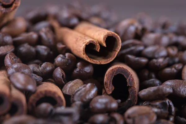 Black roasted coffee beans and grind with spices cinnamon, anise, cardamom, clove and brown sugar. With black vintage coffee grinder, scoops and cup over wood burnt background. — Stock Photo, Image