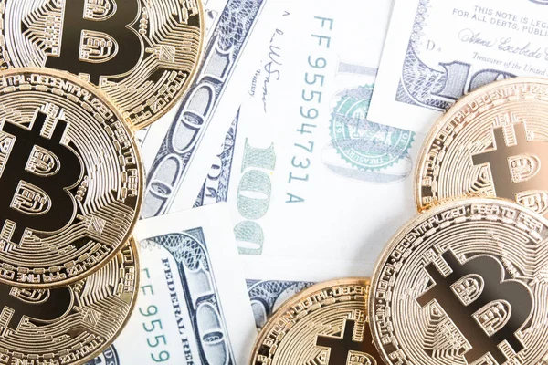 Golden bitcoin coin on us dollars close up — Stock Photo, Image