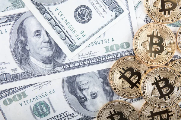 Golden bitcoin coin on us dollars close up — Stock Photo, Image