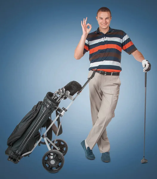 Emotional handsome golfer player pose in studio on blue and gree — Stock Photo, Image