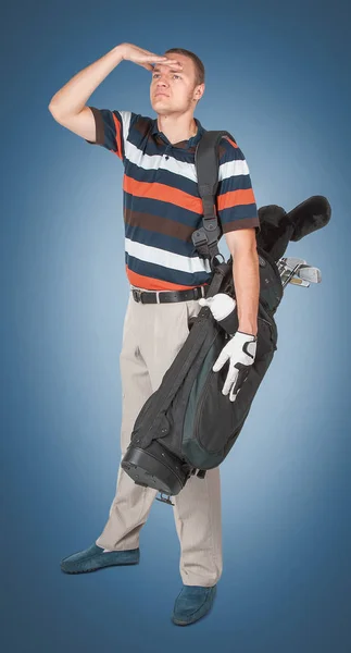 Emotional handsome golfer player pose in studio on blue and gree — Stock Photo, Image