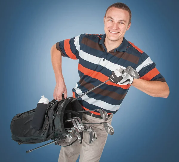 Emotionele knappe golfer speler pose in studio op blauw en gree — Stockfoto