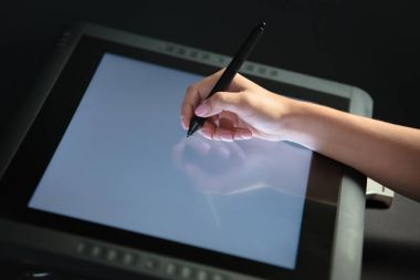 Kadın el profesyonel grafik tablet üzerinde çizim. Siyah backgro