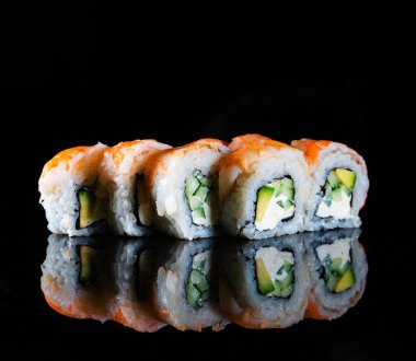 Japanese Sushi isolated on black background. Reflection in a mirror surface. Close up. Studio photo.