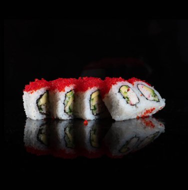 Japanese Sushi isolated on black background. Reflection in a mirror surface. Close up. Studio photo.
