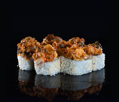 Japanese Sushi isolated on black background. Reflection in a mirror surface. Close up. Studio photo.