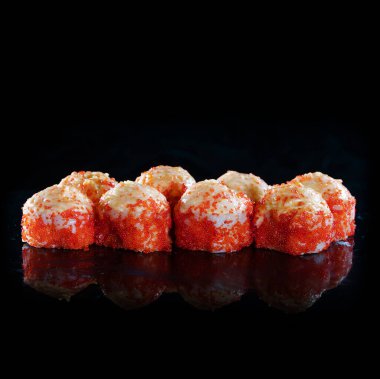 Japanese Sushi isolated on black background. Reflection in a mirror surface. Close up. Studio photo.