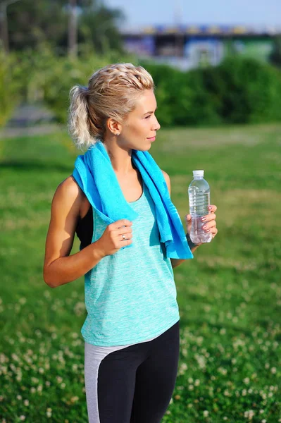 Sportive woman having rest after workout