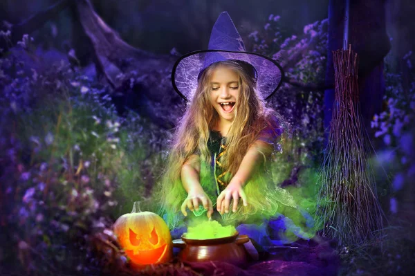 Little witch cooking green brew in the pot in the dark forest