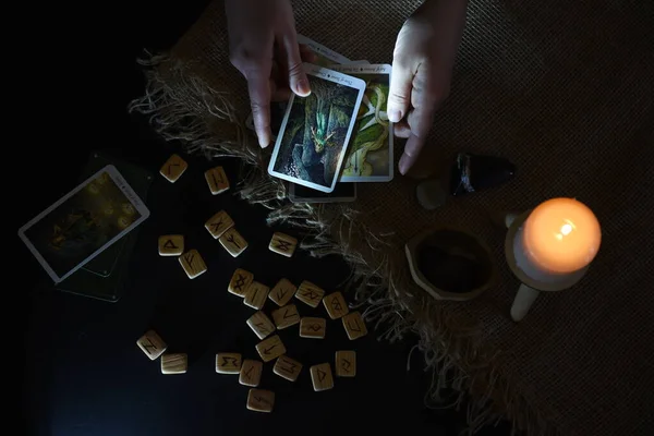 hands holding Tarot cards magic and divination