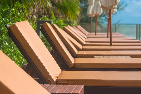 Vacation and Relaxation Concept : Daybed beside swimming pool in the resort. Stock Photo