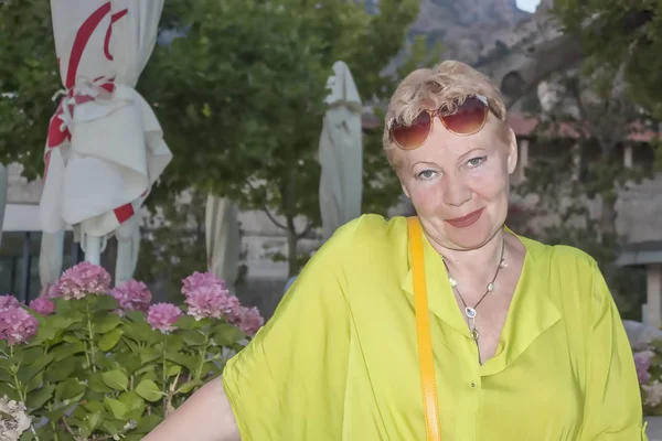 Olgun bir kadın çiçek çeşitli arka plan üzerinde