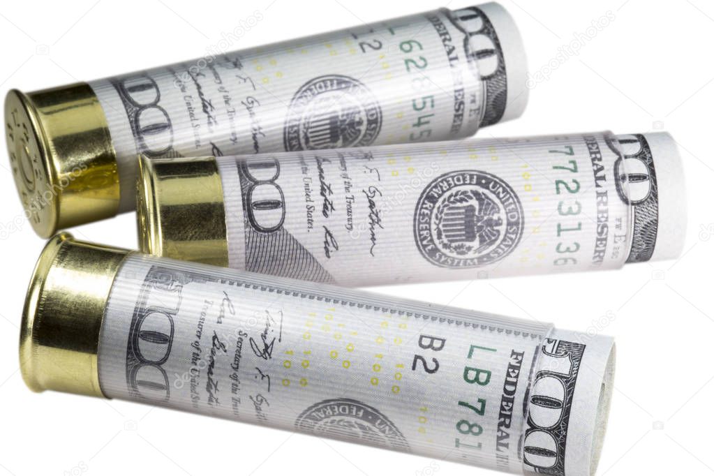 Three 12 gauge shotgun shells loaded with hundred us dollar bills. Isolated on white background.