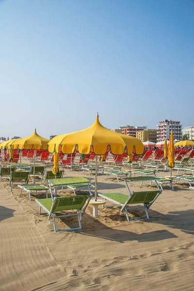 Yellow  umbrellas and chaise lounges on the beach of Rimini in Italy — Stock Photo, Image