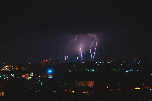 Photo of beautiful powerful lightning over big city, zipper and thunderstorm, abstract background, dark blue sky with bright electrical flash, thunder and thunderbolt, bad weather concept