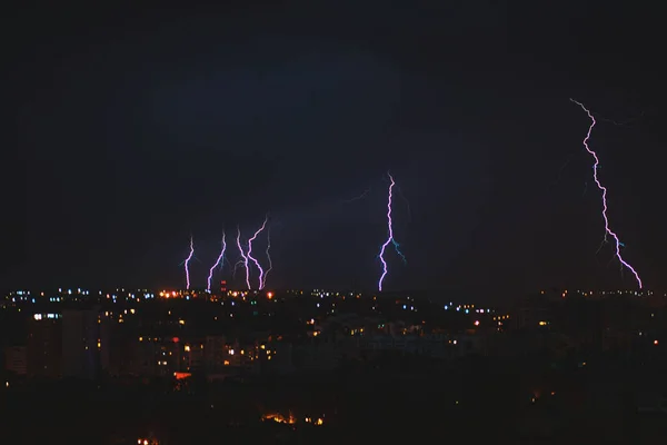 Photo of beautiful powerful lightning over big city, zipper and thunderstorm, abstract background, dark blue sky with bright electrical flash, thunder and thunderbolt, bad weather concept