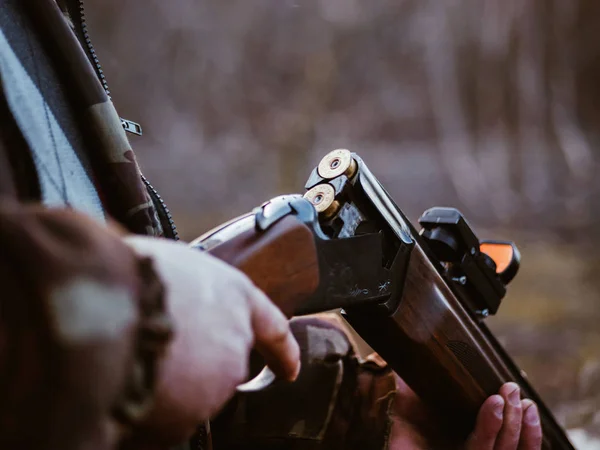 Shotgun shells and shot on black background. Loaded with bullets hunter rifle. — Stock Photo, Image