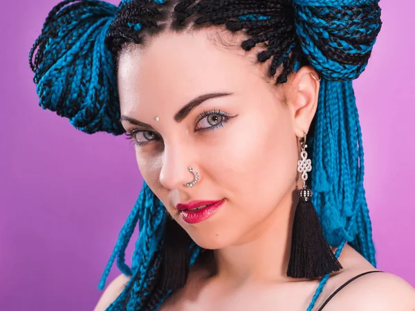 Glamour fashionable portrait of sexy woman with african blue braids hairstyle, bindi, nose ring and tassel earrings isolated on colorful background. Disco style. Hipster girl. — Stock Photo, Image