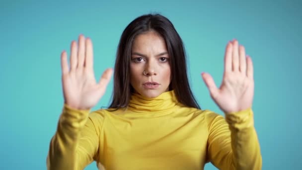 Angry annoyed woman raising hand up to say no stop. Sceptical and distrustful look, feeling mad at someone. Hispanic girl facial expressions, emotions and feelings. Body language — Stock Video