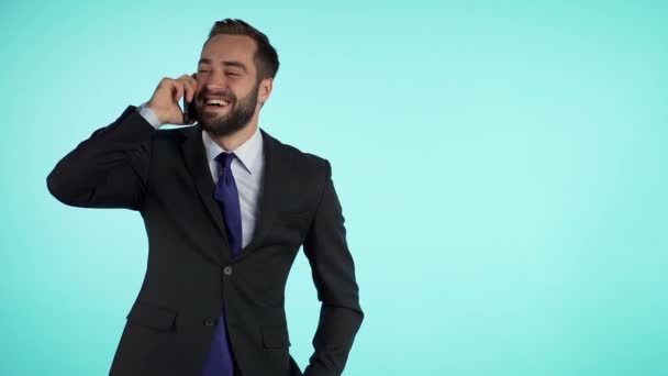 Businessman have conversation using mobile phone isolated on blue background. Copy space. Business guy in formal suit gladly talks with colleague. Office employee, wage worker, weekdays concept — Stock Video