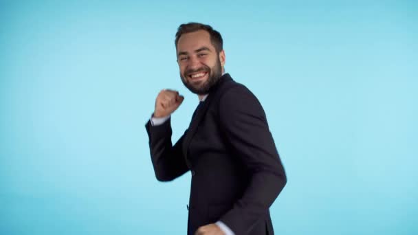 Förvånad glad glad affärsman rolig dans på blå bakgrund. Man visar ja gest av seger, uppnådde han resultat, mål. — Stockvideo