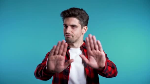 No, never, handsome brunette man disliking and rejecting gesture by stop sign. 4k. Portrait of young successful confident guy isolated on blue — Stock Video