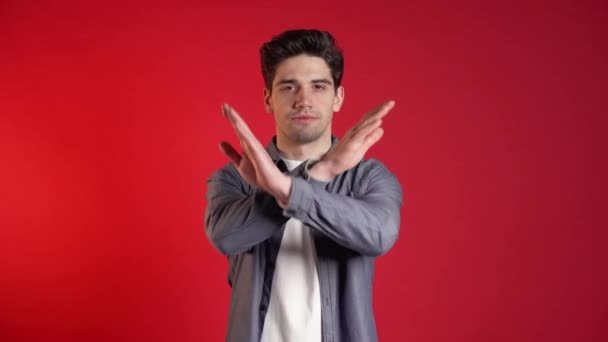 Man disapproving with no crossing hands sign make negation gesture. Denying, Rejecting, Disagree, Portrait of handsome guy on red background — Stock Video