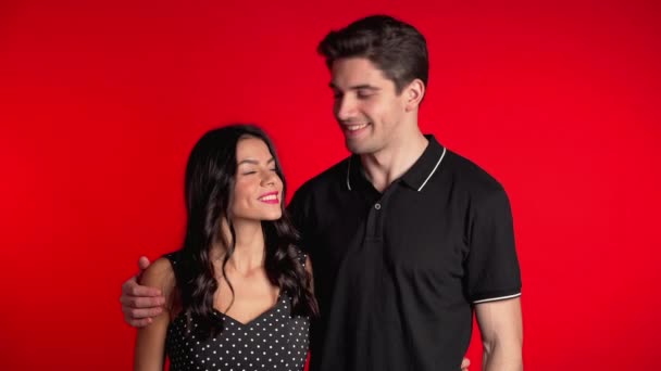Porträt eines jungen Paares auf rotem Studiohintergrund. Liebe, Urlaub, Glückskonzept. — Stockvideo