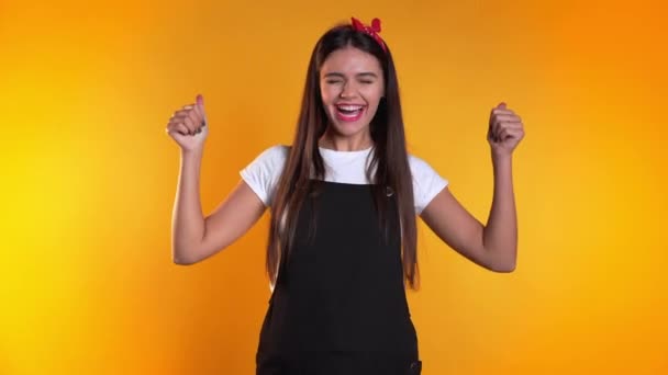 Young woman with perfect make-up making thumbs up sign over yellow background. Winner. Success. Positive girl smiles to camera. Body language. — 비디오