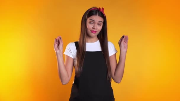 Cute woman showing bla-bla-bla gesture with hands and rolling eyes isolated on yellow background. Empty promises, blah concept. Lier. — Stock Video