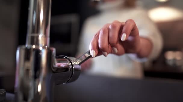 Womans hand open crane with water in modern kitchen and washing dirty plate. — 비디오