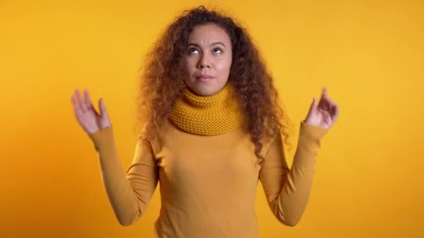 Cute woman showing bla-bla-bla gesture with hands and rolling eyes isolated on yellow background. Empty promises, blah concept. Lier. — Stock Video