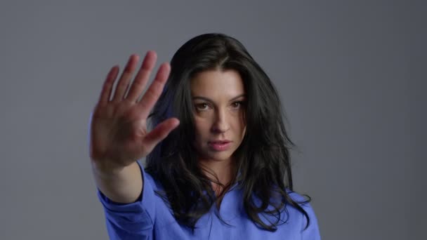 Mature woman disapproving with NO hand sign gesture. Denying, rejecting, disagree, portrait of beautiful adult lady on grey background — Stock Video