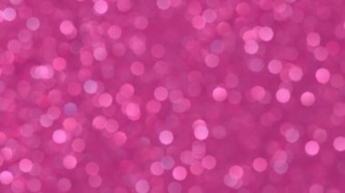 Parlak pembe bokeh ışıltılarıyla soyut bir arka plan. Parlayan Parçacıklar. Odaklanamayan dairesel fakül. Doğal yüzen organik soyut arkaplan. Noel ve Mutlu Yıllar.