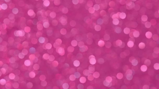 Abstracte achtergrond met glanzende roze bokeh sprankelingen. Glinsterende deeltjes. Gedeocaliseerde ronde facula. Natuurlijke drijvende organische abstracte achtergrond. Kerstmis en Gelukkig Nieuwjaar. — Stockvideo