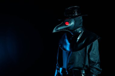 Portrait of plague doctor with crow-like mask isolated on black background. Creepy mask, halloween, historical terrible costume concept. Epidemic clipart